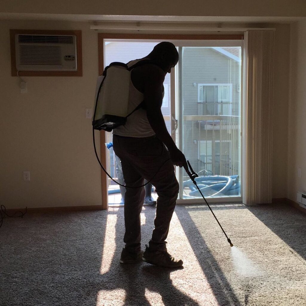 A person performing professional carpet cleaning services at a home or business by Flawless Home & Business Cleaning LLC in Fargo, ND.