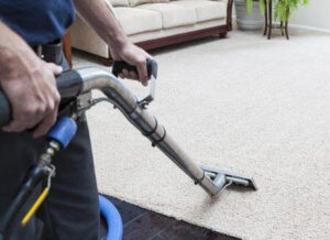 A person using a professional wand to clean a carpet, a service by Chinook Services Silver Lake in Everett, WA