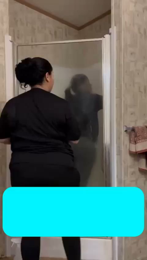 A person cleaning a shower door as part of house cleaning services by Costa cleaning services in Salisbury, MD.