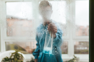 A person cleaning a residential window for Duval Commercial Cleaning in Jacksonville, FL