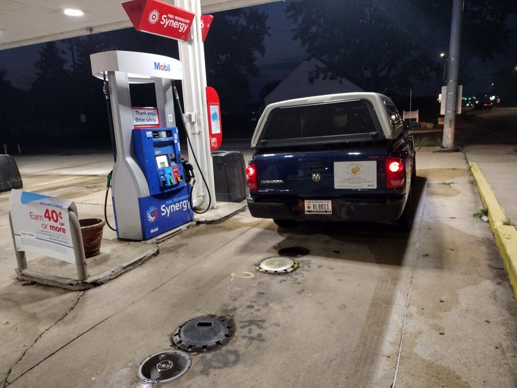 A person clearing debris from a concrete patio next to a house for Satisfaction Cleaning in Athens, AL.