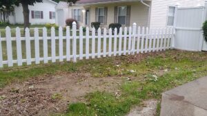 A person pressure washing a concrete patio and wooden deck for Satisfaction Cleaning in Athens, AL.