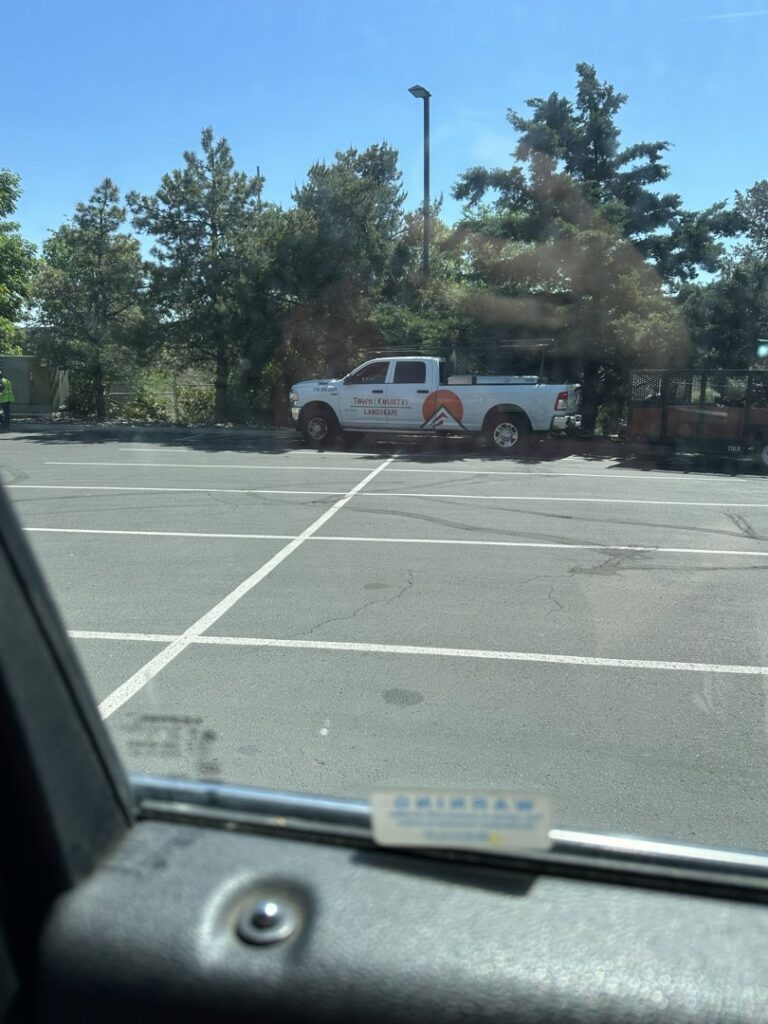 A person using a snow blower to clear a snow-covered path or sidewalk for Town & Country Landscape Maintenance in Reno, NV.