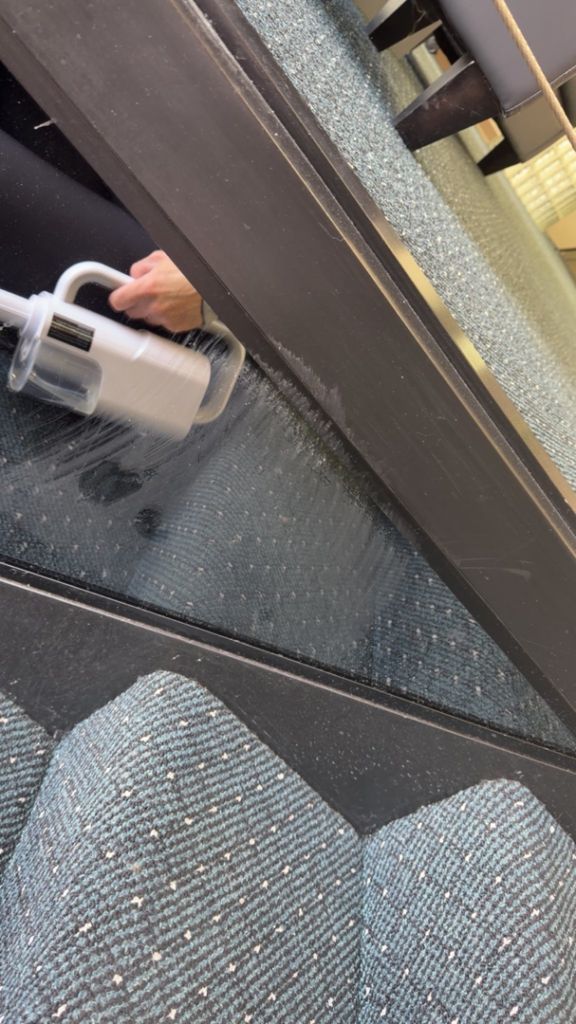 A professional house cleaner from C&K Cleaning Services, LLC vacuuming carpeted stairs in Cedar Rapids, IA