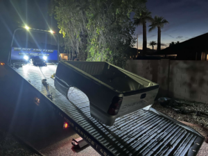 A pickup truck bed being transported on a flatbed tow truck by CnD towing in Phoenix, AZ.