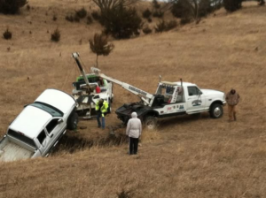 A white pickup truck being recovered from a ditch by Lone Tree Towing in Grand Island, NE.
