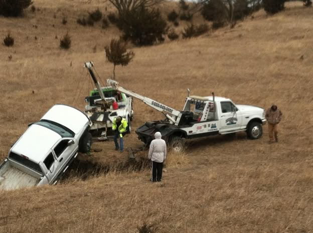 A white pickup truck being recovered from a ditch by Lone Tree Towing in Grand Island, NE.