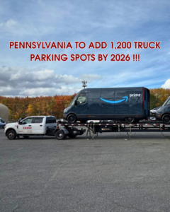 A white pickup truck from Ebash Towing LLC transporting two Amazon Prime vans on a flatbed trailer in Philadelphia, PA.