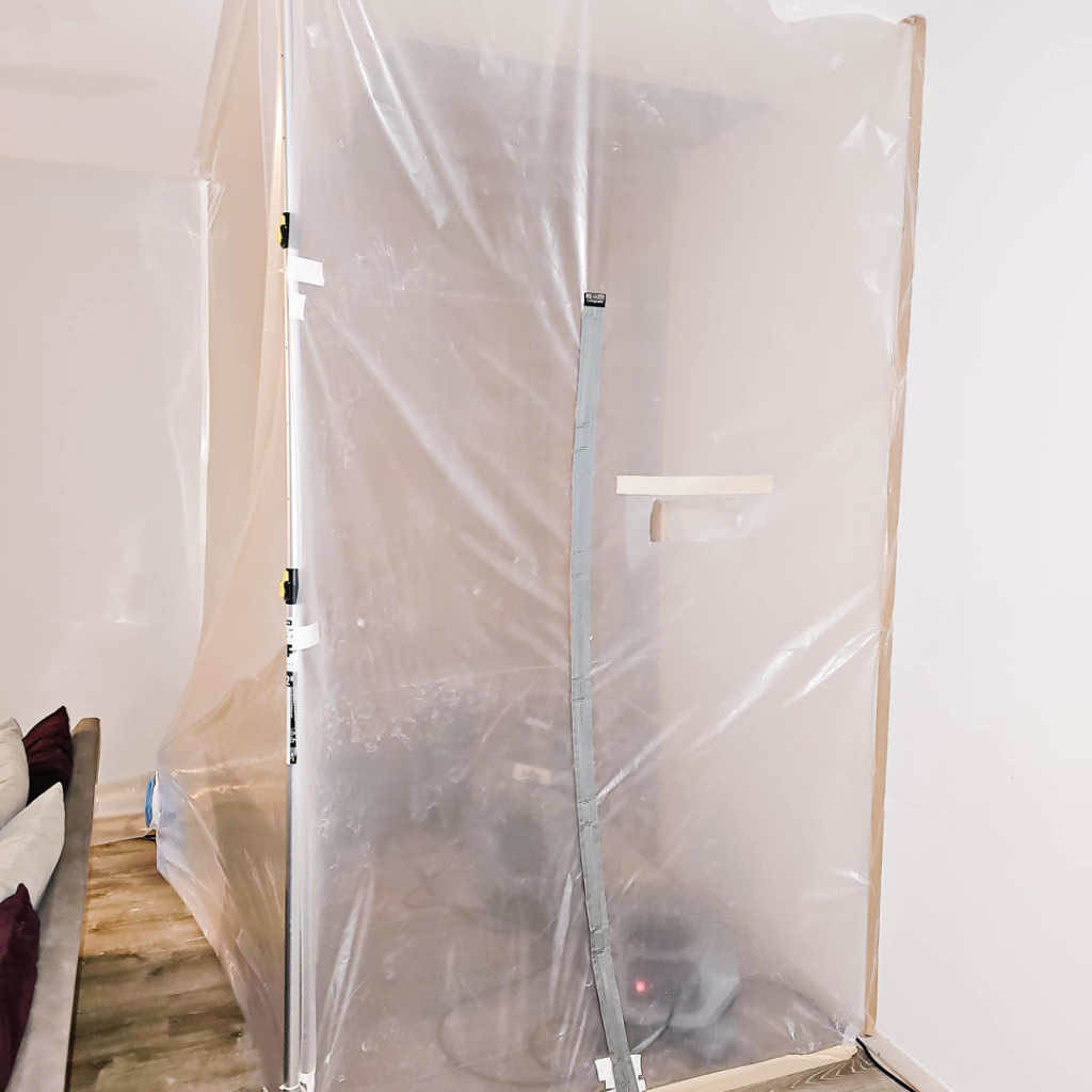 A room sealed with plastic sheeting to contain the work area during water damage cleanup by Remont Restoration in Hagerstown, MD.