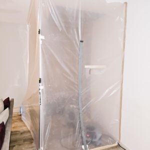 A room sealed with plastic sheeting to contain the work area during water damage cleanup by Remont Restoration in Hagerstown, MD.