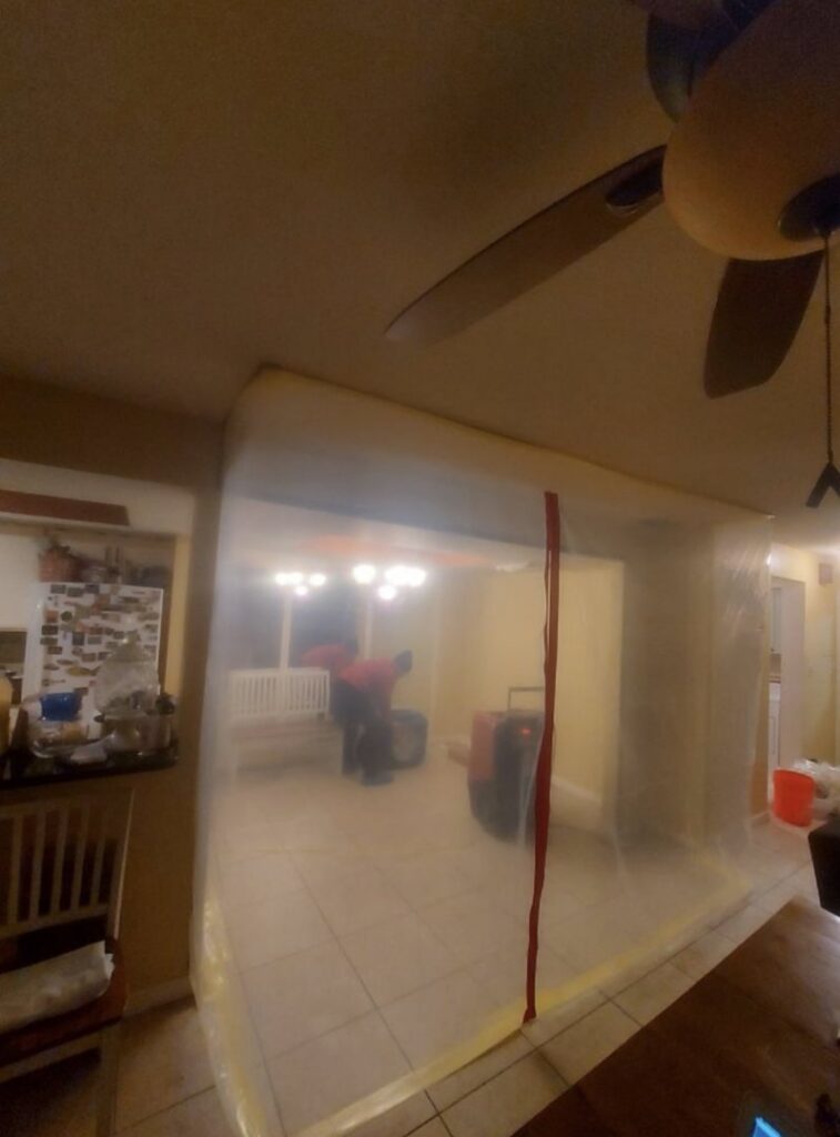 Plastic sheeting used to create a containment zone during water damage restoration, ensuring controlled drying and remediation by Standard Restoration in Salt Lake City, UT.