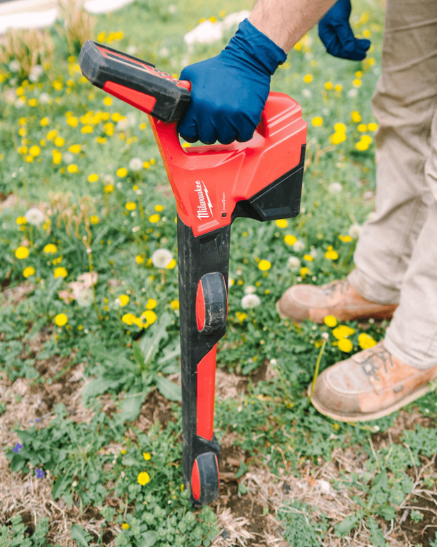 A plumber using a utility locator to find underground pipes for Bright Side Plumbing in Overland Park, KS.