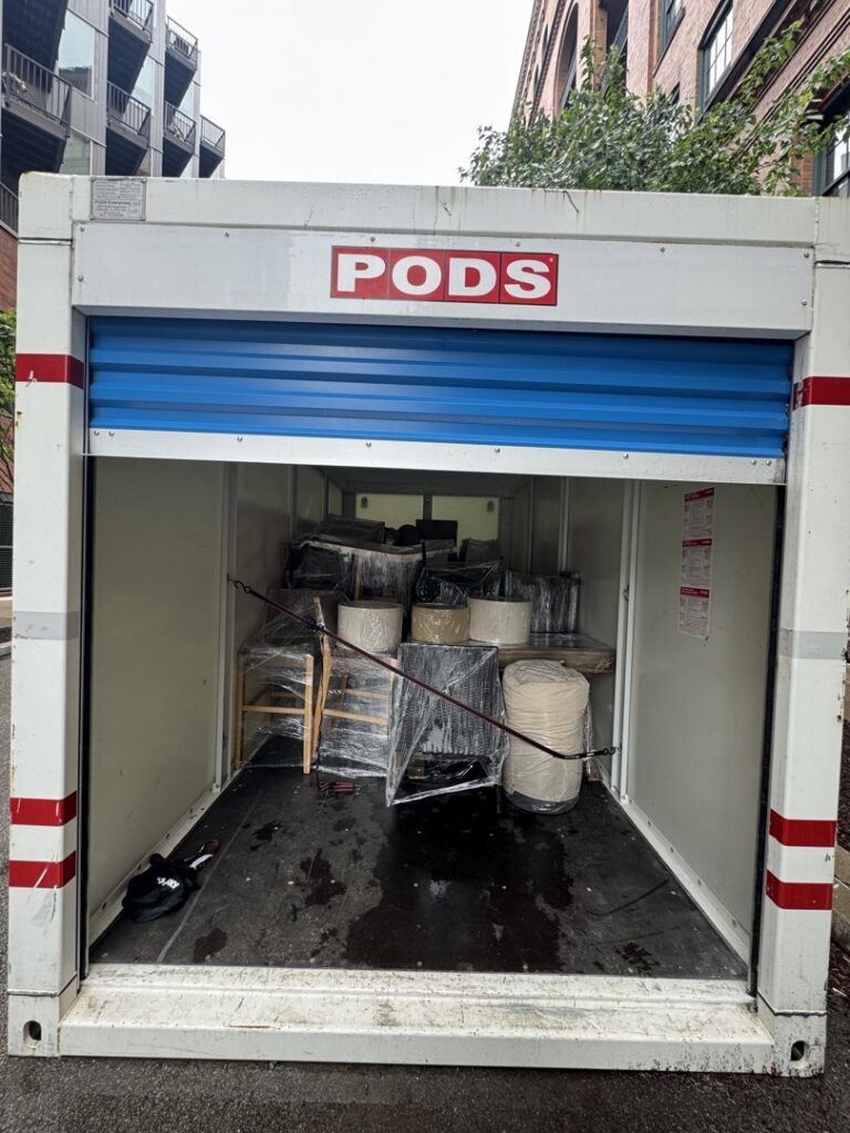 A PODS container partially loaded with furniture and wrapped items by PittMovers in McKees Rocks, PA