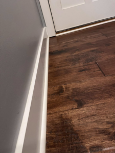 A polished hardwood floor and clean white baseboard, showcasing attention to detail by Blue Line Cleaning Services in Rock Hill, SC.