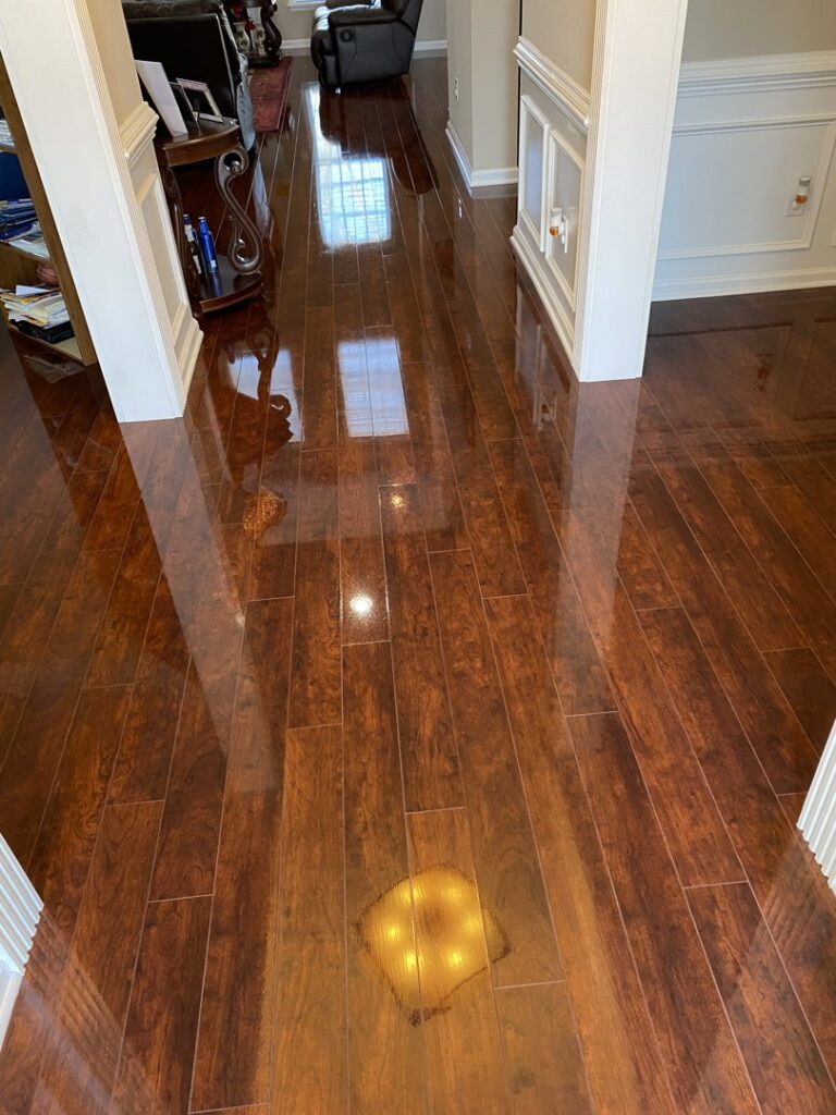 A gleaming, polished hardwood floor in a hallway, cleaned by Five Star Cleaning Service in Pasadena, MD.