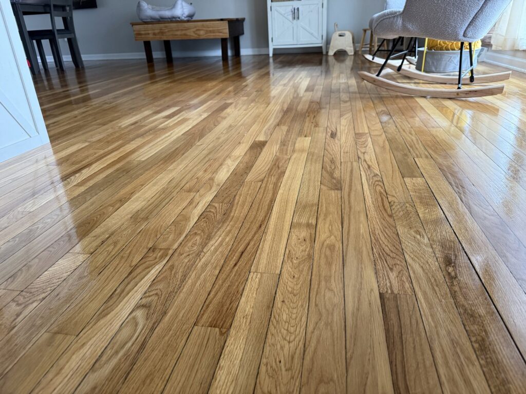 A beautifully polished hardwood floor, showcasing the pristine results delivered by Messy To Clean in Aurora, IL.