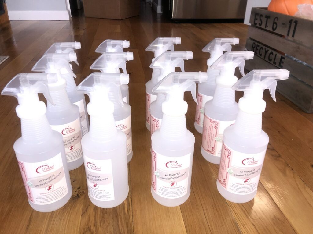 Bottles of Polished Housekeeping Services' all-purpose cleaner and disinfectant, ready for use in Londonderry, NH.