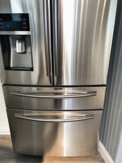 A perfectly polished and streak-free stainless steel refrigerator, cleaned by Polished Housekeeping Services in Londonderry, NH.