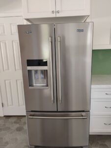A polished stainless steel refrigerator, meticulously cleaned by Tessa's Cleaning Service in Chesapeake, VA.