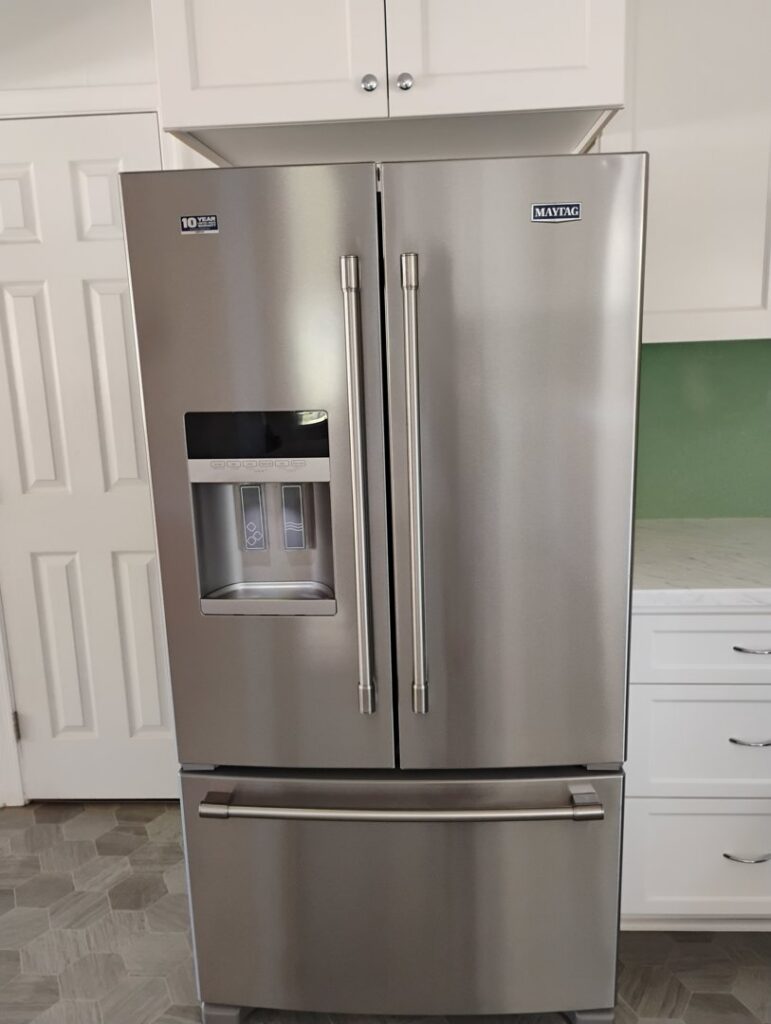 A polished stainless steel refrigerator, meticulously cleaned by Tessa's Cleaning Service in Chesapeake, VA.