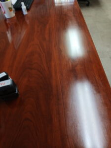 A beautifully polished wooden surface, reflecting light after cleaning by Mama's Touch Cleaning Service LLC in Evansville, IN.