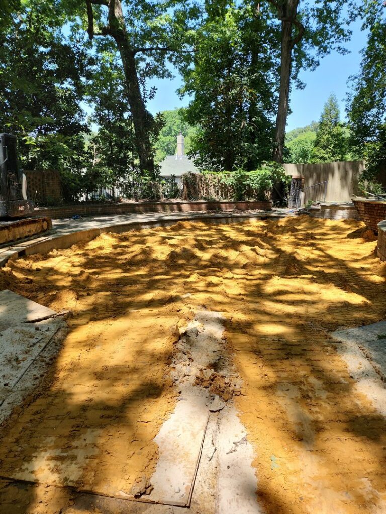A swimming pool being filled with dirt as part of a pool removal service by East Shelby Demolition & Pool Removal in Olive Branch, MS.
