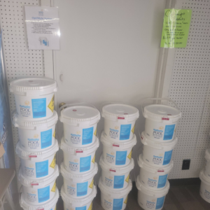 Stacks of Pool Breeze chlorine buckets for sale at Pool Queen in Fairmont, WV.