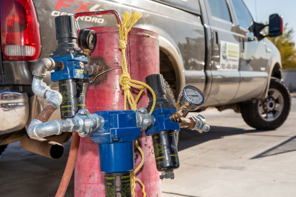 Specialized pool cleaning equipment, likely an air compressor or blaster, used by Pool Tile Cleaning Vegas in Las Vegas, NV.