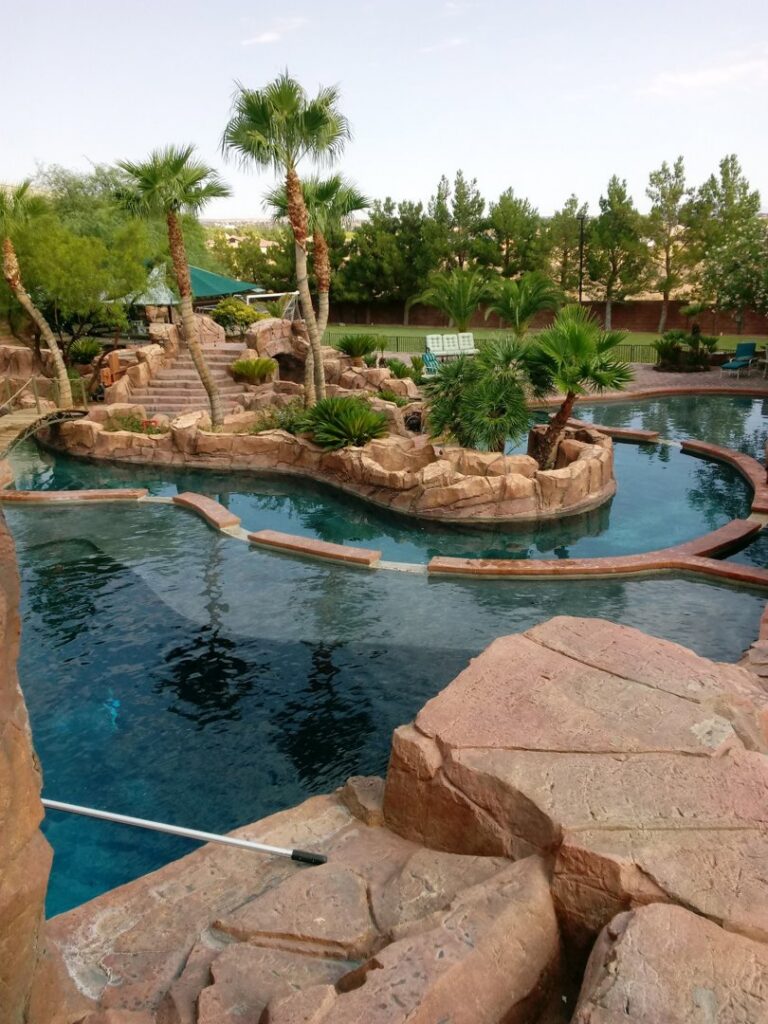 A pool cleaning pole visible in a large swimming pool by Suburban Pool Company in Germantown, WI.