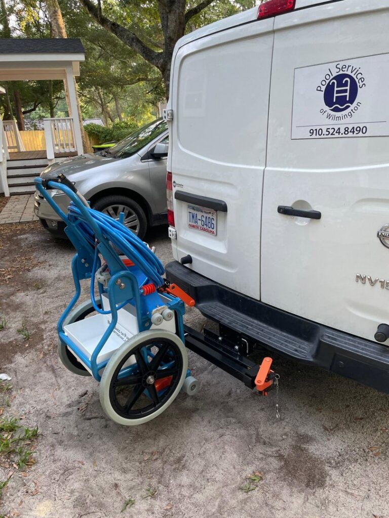 A Pool Services of Wilmington service van with cleaning equipment attached, ready for jobs in Wilmington, NC.