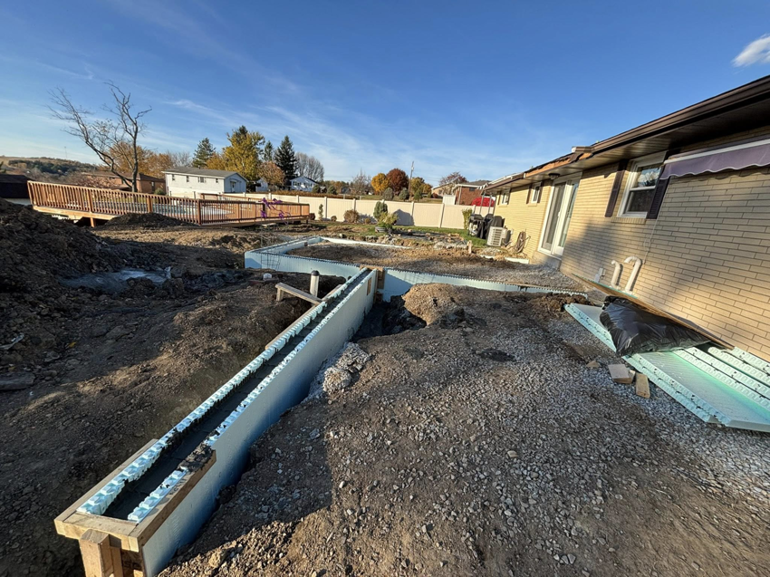 An overview of a pool construction site in a backyard, showing installed forms by GM Contracting of West Virginia in Morgantown, WV.
