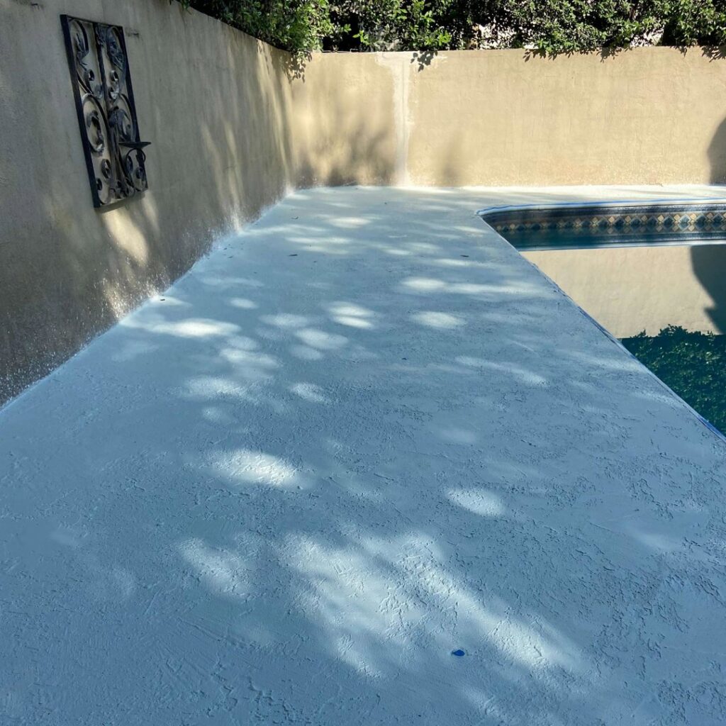 A newly resurfaced and waterproofed pool deck by HNO Waterproofing & Slab Lifting Pros in Concord, NC.