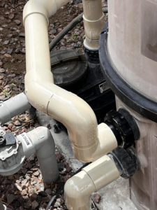 Detailed view of pool equipment and plumbing during an inspection by Vegas Integrity Pool Service in Las Vegas, NV.