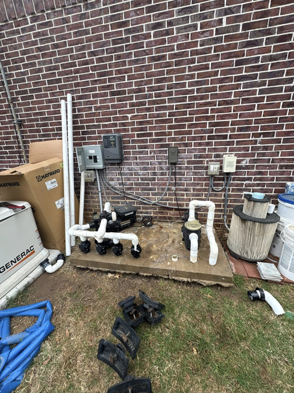 Pool equipment installation in progress by AW Pool Service in Tulsa, OK, showing pumps, pipes, and filters.