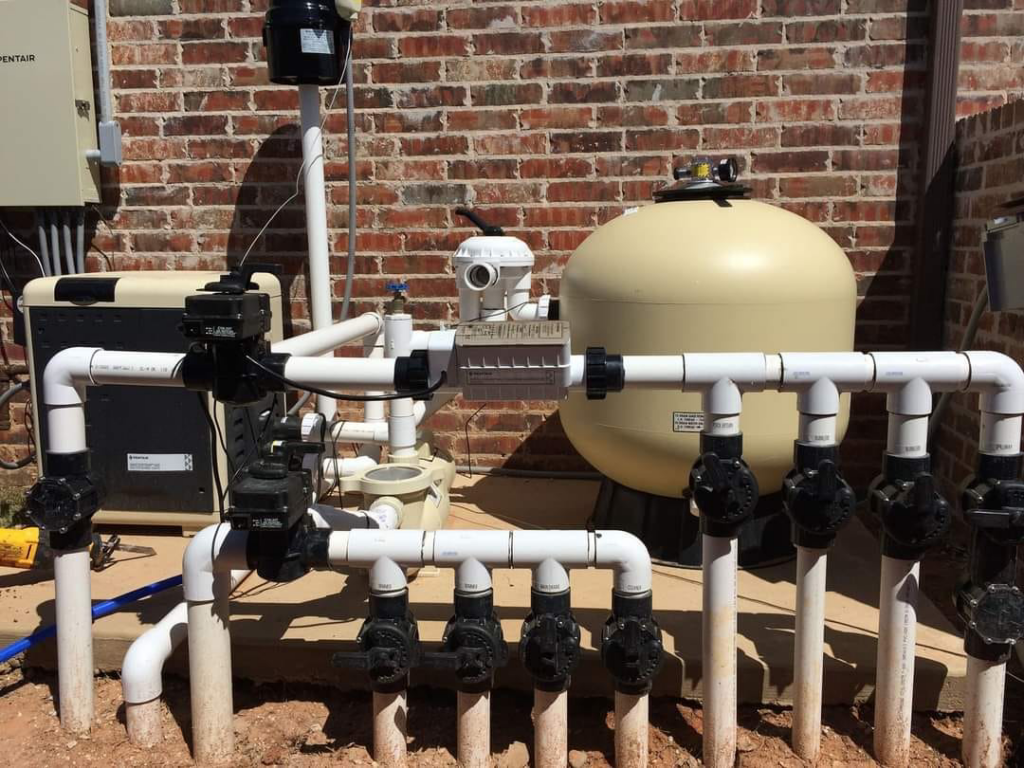 A professionally installed pool equipment pad with pumps, filters, and piping by J.R. Pools in Lubbock, TX.