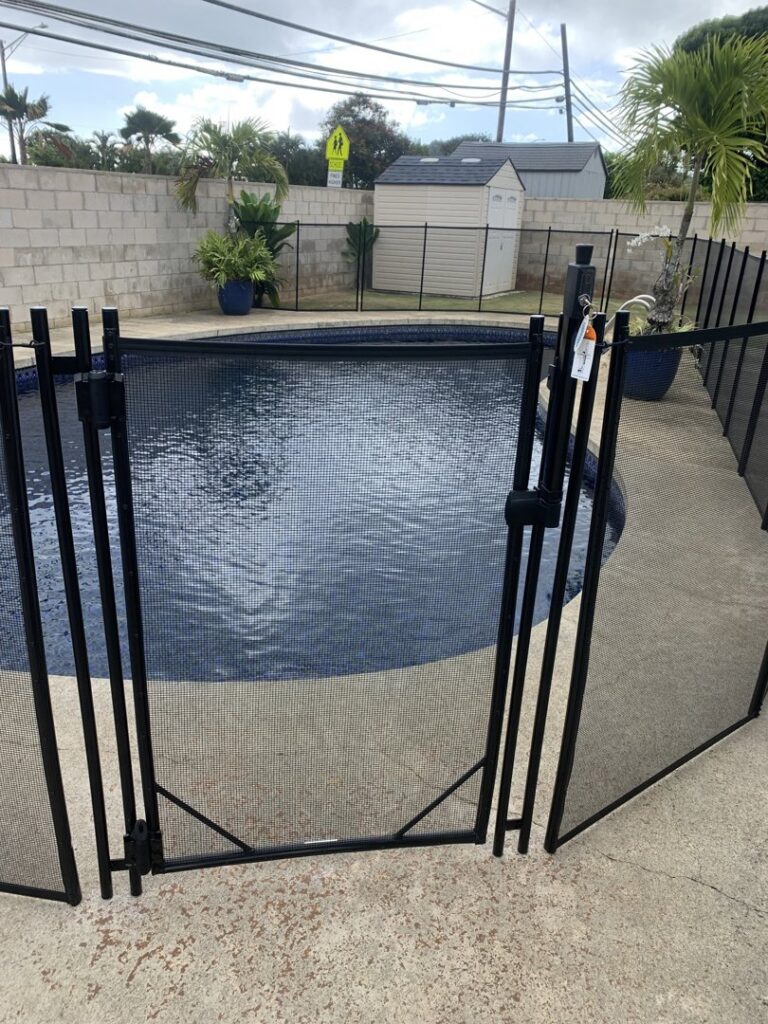 A close-up of a pool fence gate installation by Guardian Pool Fence Systems of Hawaii, ensuring secure access to a pool in Honolulu, HI.