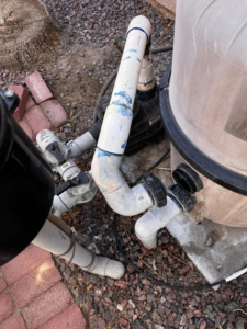 Close-up of a pool filter and plumbing system, showing maintenance work by Vegas Integrity Pool Service in Las Vegas, NV.