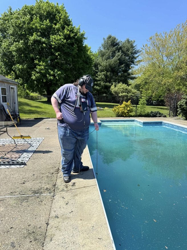 A technician using specialized equipment for pool leak detection at South Shore Leak Solutions in Quincy, MA
