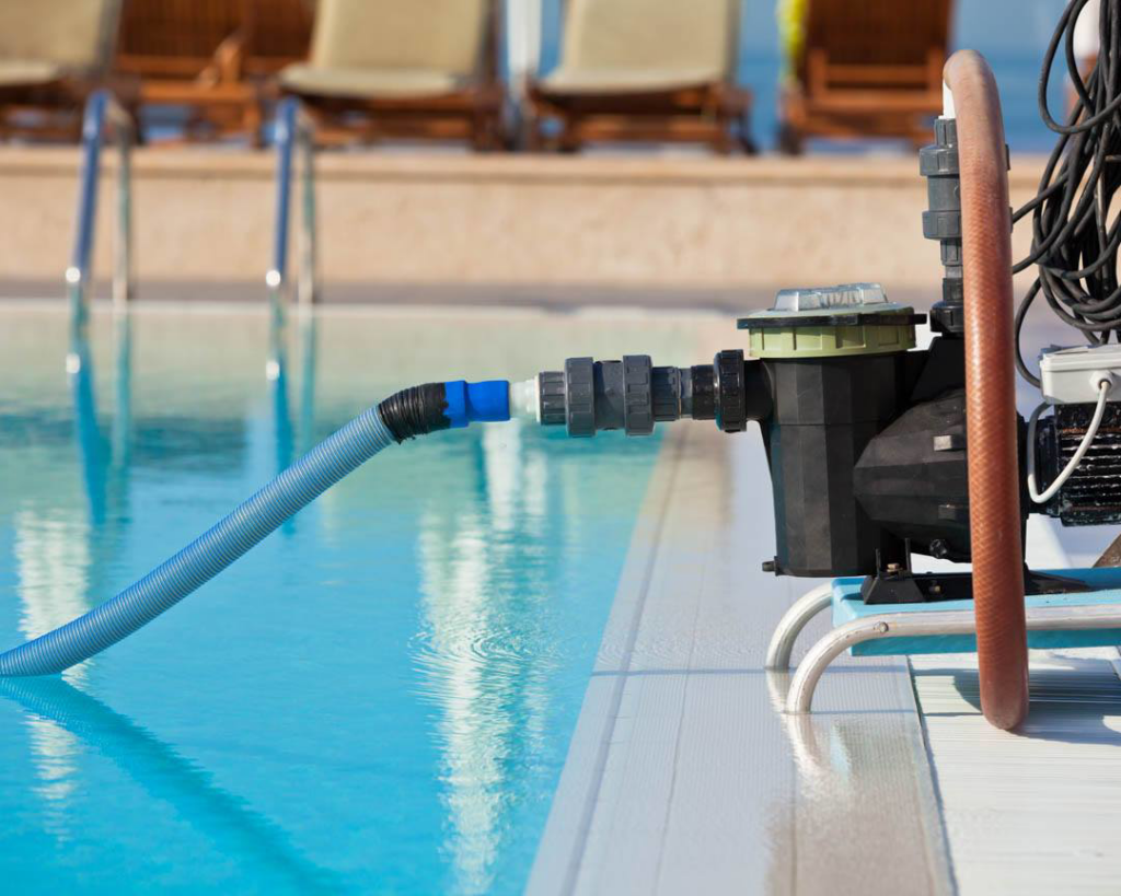 A pool pump and hose connected to a swimming pool for circulation and cleaning by HappyPools LLC in North Las Vegas, NV.