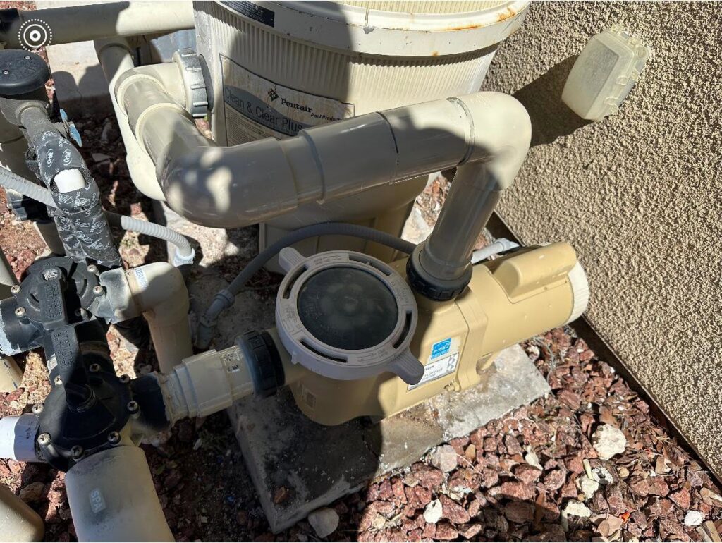 A well-maintained pool pump and filter system, essential for clean water, serviced by Overflow Poolz LLC in Las Vegas, NV.