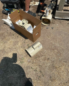 Pool pump parts on the ground for repair or replacement by Retrowave Pool & Spa in Nampa, ID.