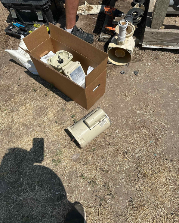 Pool pump parts on the ground for repair or replacement by Retrowave Pool & Spa in Nampa, ID.