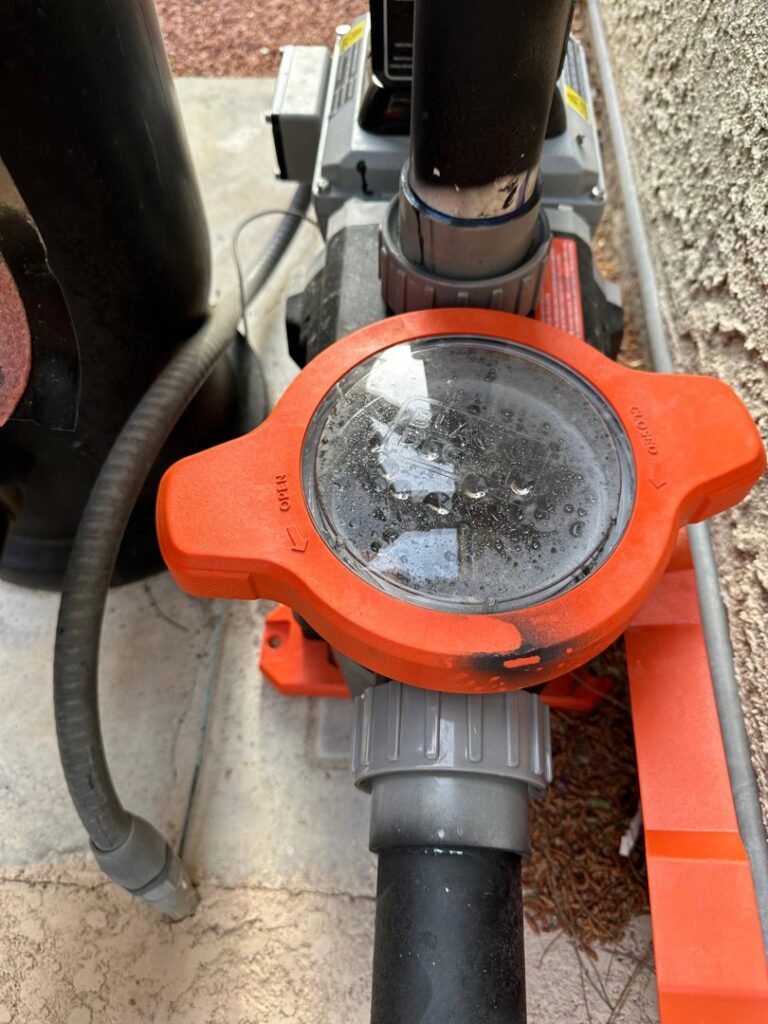Close-up of a pool pump valve and lid during a routine inspection by Overflow Poolz LLC in Las Vegas, NV.