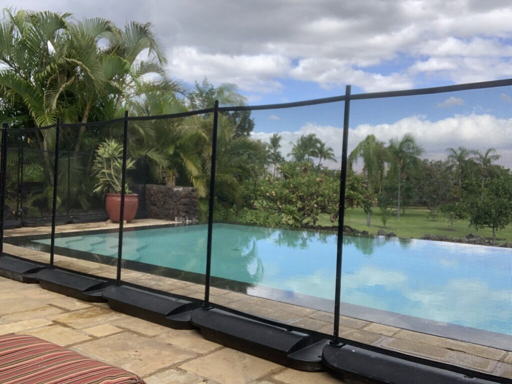 A pool safety fence with weighted bases installed by Guardian Pool Fence Systems of Hawaii, securing a residential pool in Honolulu, HI.