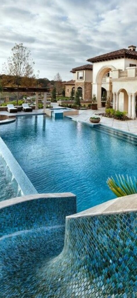 A pool vacuum hose and pole actively cleaning a residential pool by Vegas Integrity Pool Service in Las Vegas, NV.