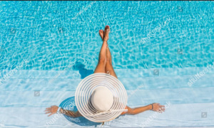 A person performing pool vacuuming service with a hose and pole for Patriot Pool Cleaning Services in Naples, FL.