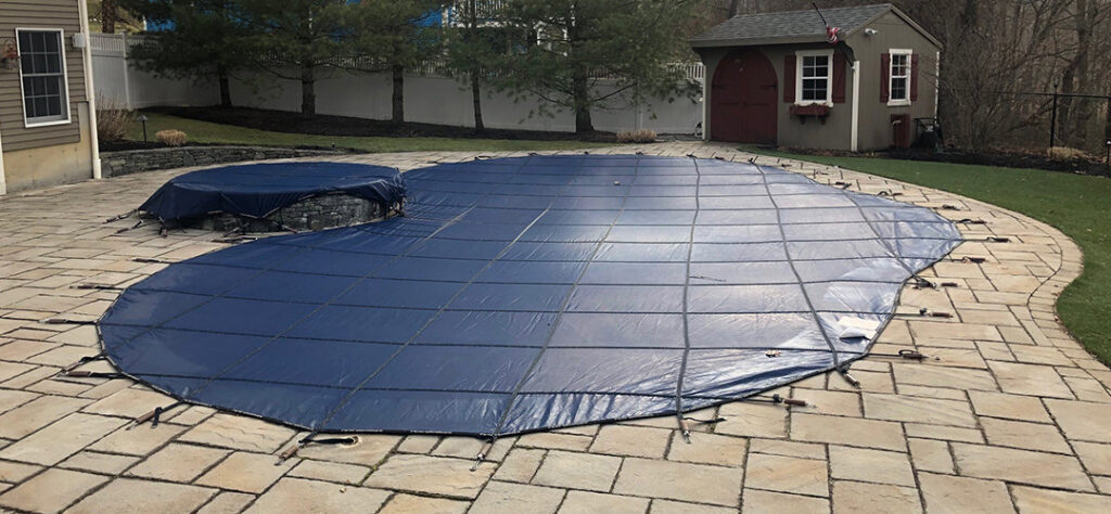 A pool covered for winter, demonstrating a pool closing service by Chlorine Clean Pool Services in Wilmington, DE.