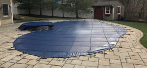 A pool covered for winter, demonstrating a pool closing service by Chlorine Clean Pool Services in Wilmington, DE.