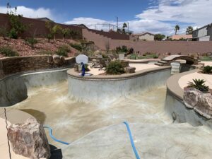 An empty pool showing significant calcium buildup and stains on the tile and surface, awaiting cleaning by Pool Tile Cleaning Vegas in Las Vegas, NV.