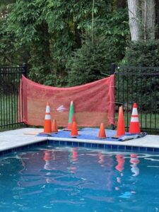 A pool work area secured with safety cones and netting, indicating ongoing leak repair or maintenance by South Shore Leak Solutions in Quincy, MA